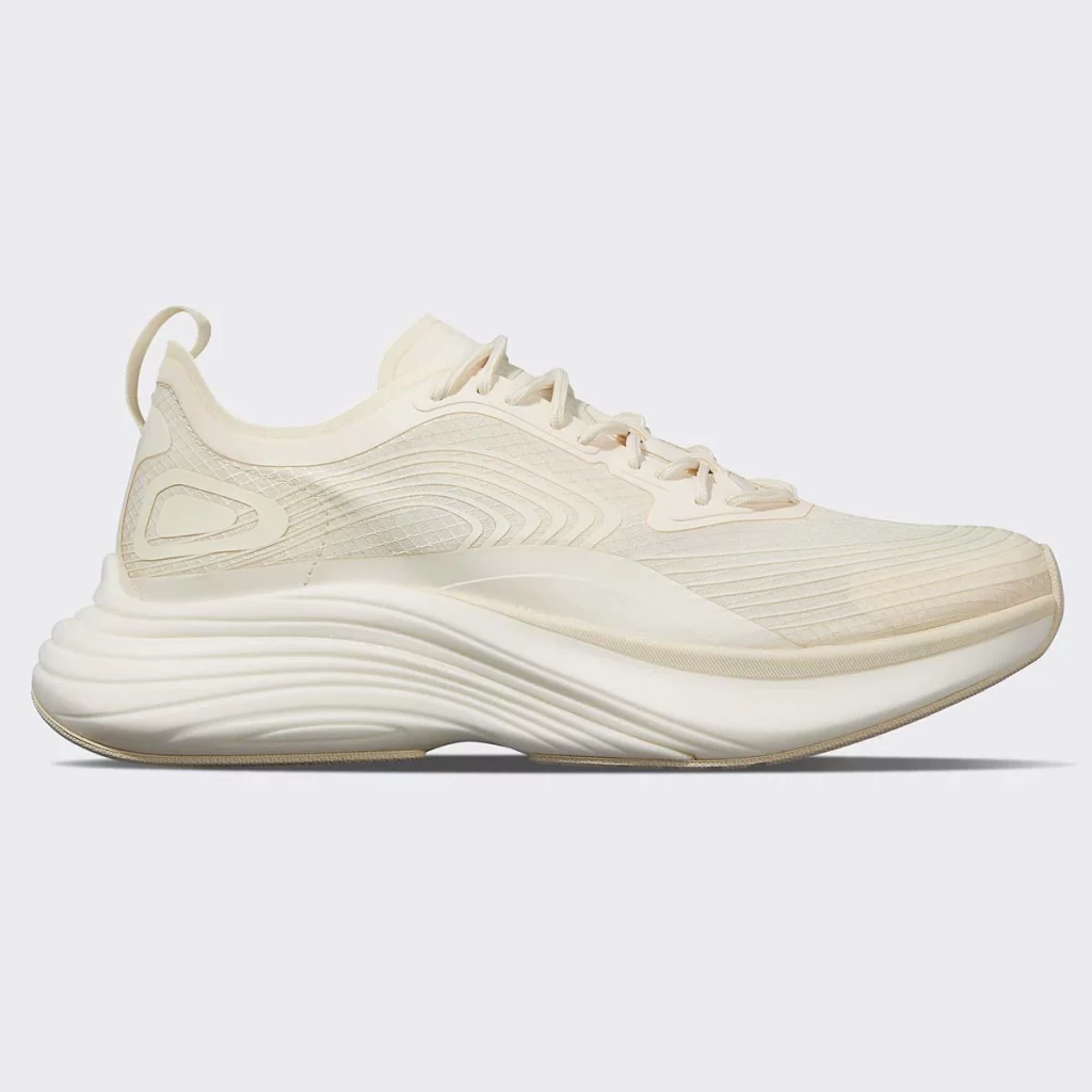 Cream sneakers with swirly design pattern.