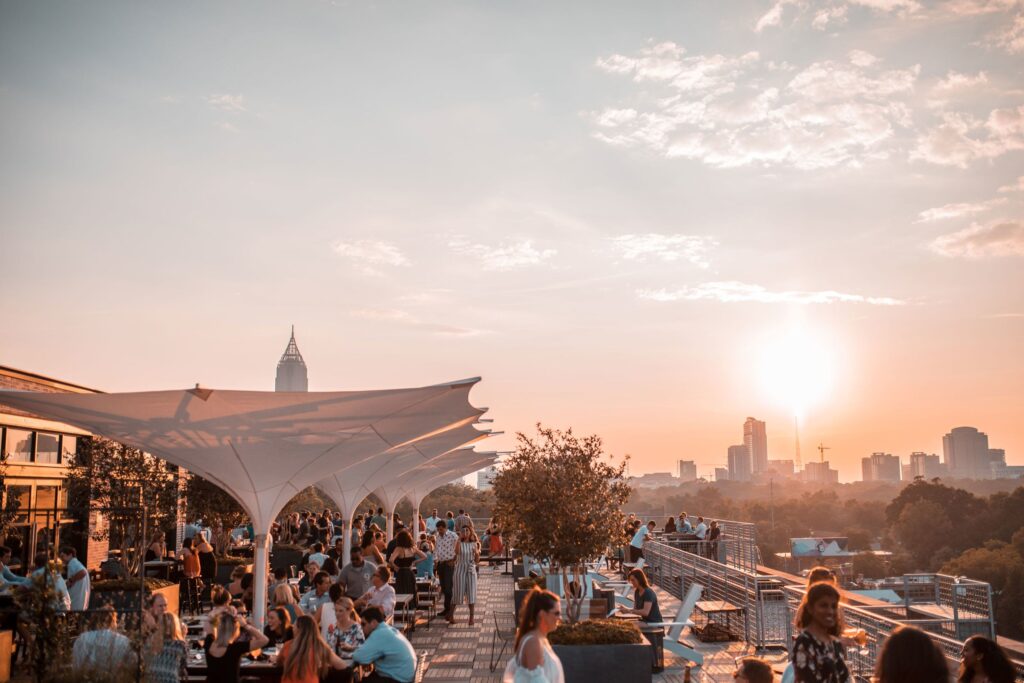 An image depicting the outside seating area of a restaurant, strategically positioned to offer guests a breathtaking view of the city's skyline.