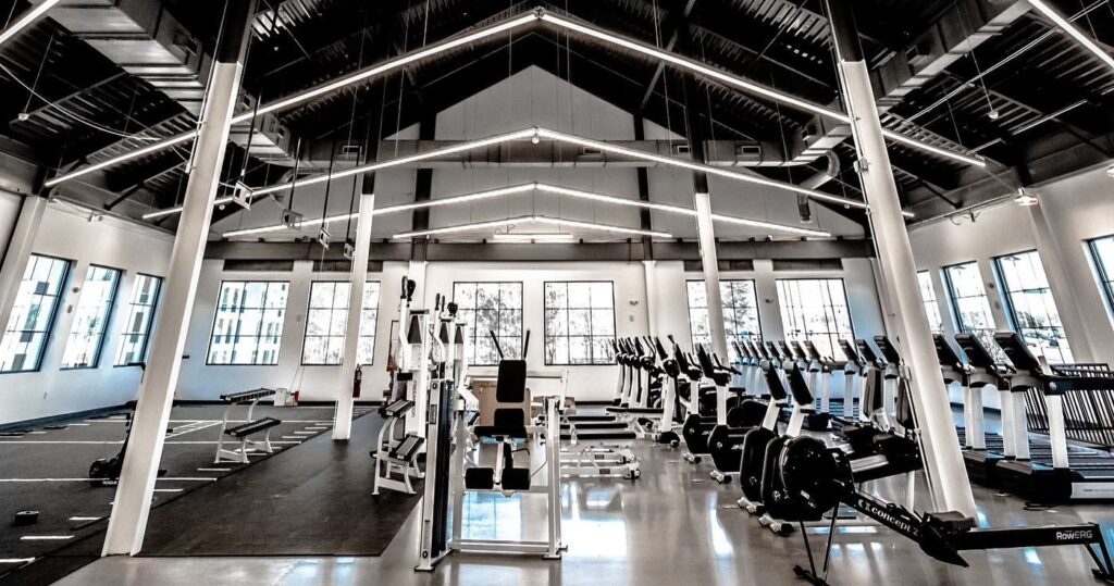 An image of a high-end gym with white and black colored equipment.