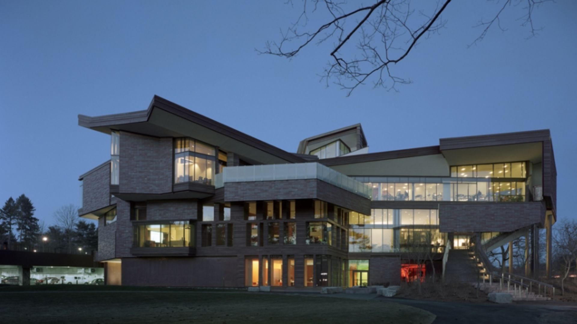 A futuristic, luxury home boasting four floors of sleek design, characterized by numerous large windows that showcase its innovative architecture