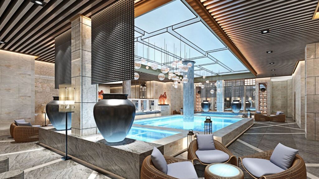 A luxurious wellness spa with marble walls and flooring, featuring a pool and lounge chairs.