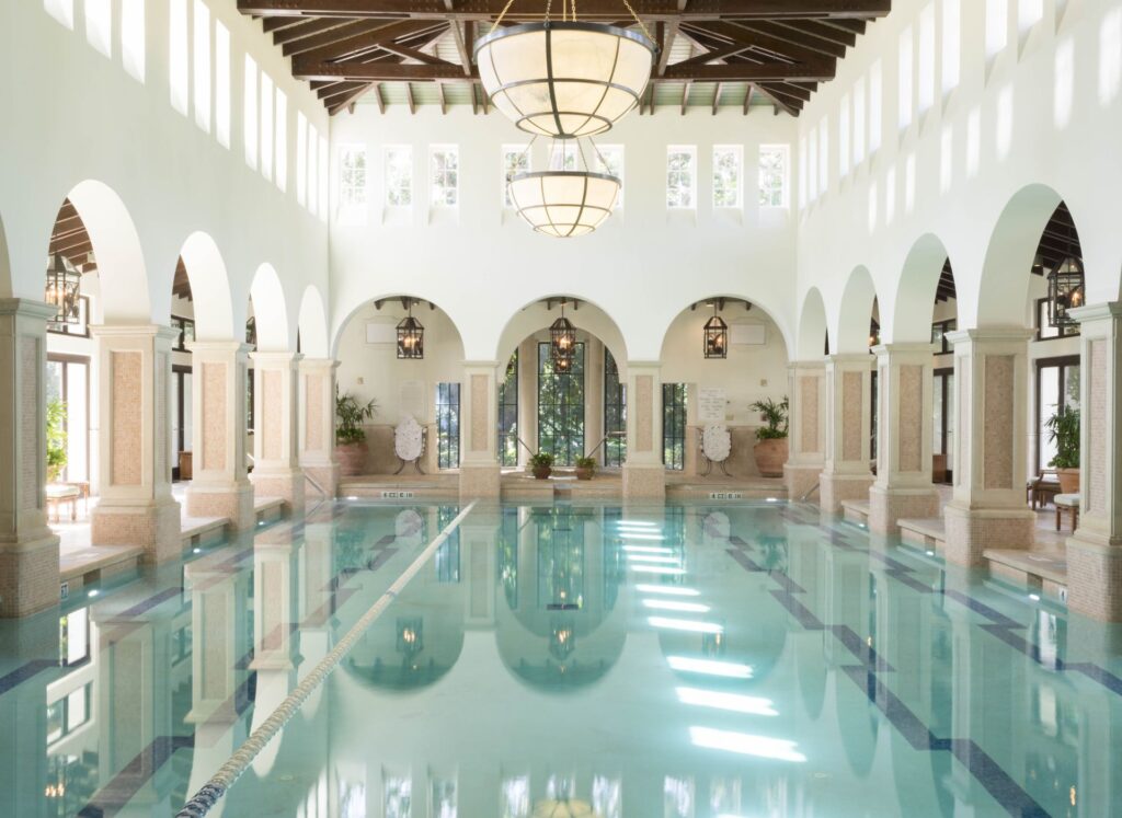 A picture of a luxurious wellness spa pool with structured columns nearby