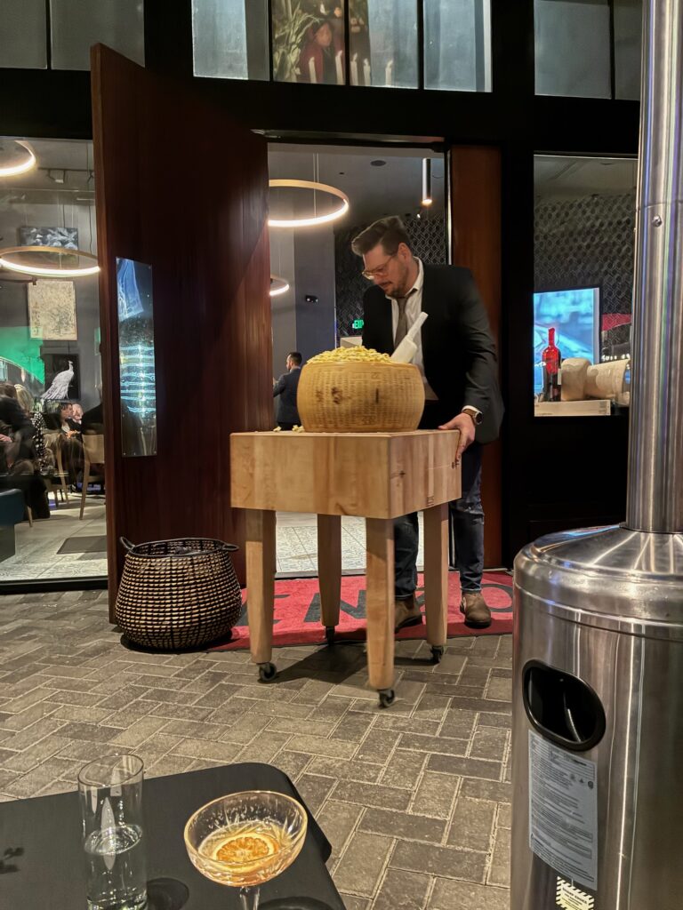 ENZO's Chef Andrea Montobbio brings out a wheel of parmesan full of buttered popcorn