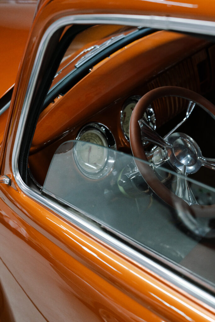 Close-up of custom orange leather interior and polished dashboard detailing — showcasing Elite Customs’ attention to fine finishes.