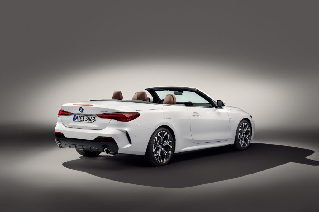 2025 BMW M440i Convertible in Dravit Grey Metallic with roof down, parked in studio lighting