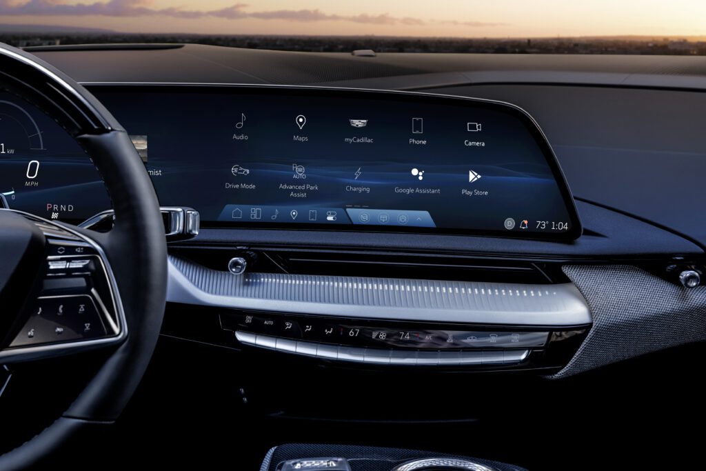 Close-up of central infotainment touchscreen and dashboard controls with ambient lighting.
