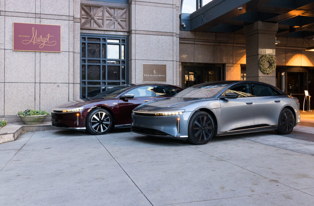 Lucid Air parked in front of Four Seasons Hotel Atlanta, showcasing the luxury EV experience offered through the hotel’s exclusive guest partnership.